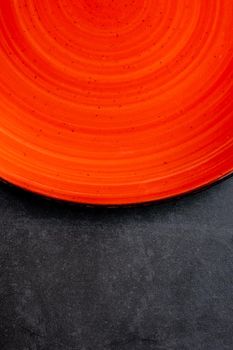 empty red plates on black stone background