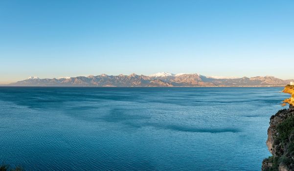 Panoramic view of Antalya on a sunny winter day with sea and snowy mountains