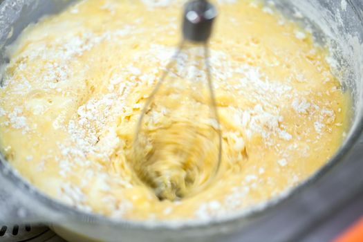 Motion blur photo of mixing homemade delicious cake