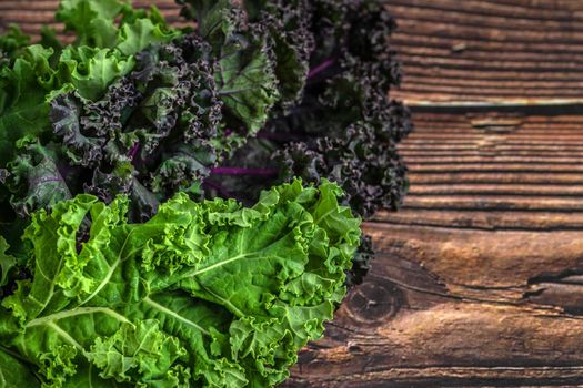 green leafy kale vegetable isolated on wooden table background