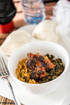 Regional African Food on white plate on wooden background
