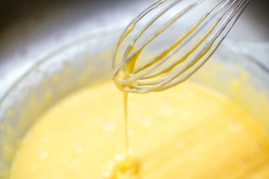 delicious Homemade cake mix spilling from tip of mixer