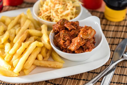 Regional African Food on white plate on wooden background