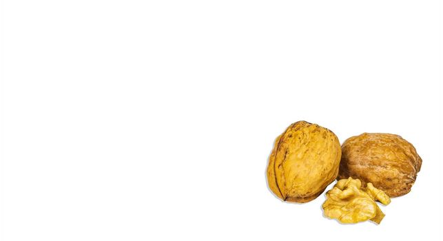Two halves of a split walnut isolated on a white background. Juglans regia. Walnut shell. Healthy food. Iodine in nuts. Nut core. Vegetarian food. Culinary ingredient. White background.