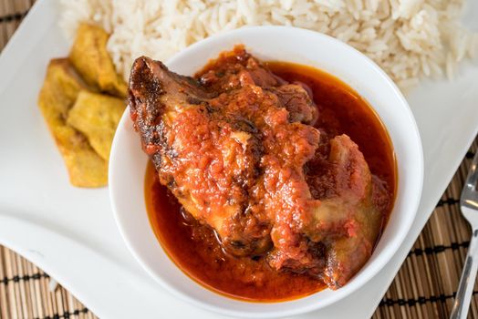 Regional African Food on white plate on wooden background