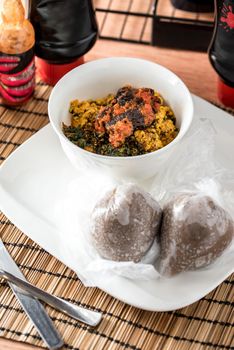 Regional African Food on white plate on wooden background