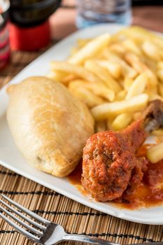 Regional African Food on white plate on wooden background