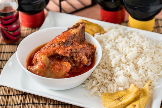 Regional African Food on white plate on wooden background
