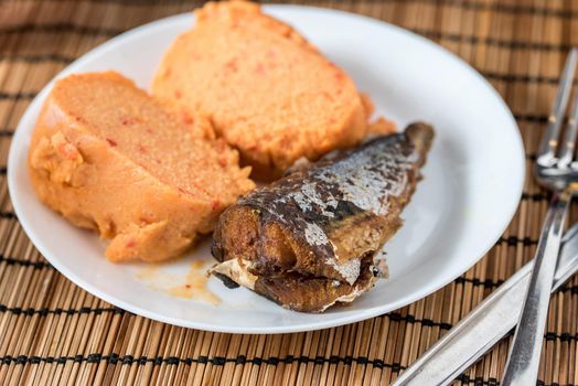 Regional African Food on white plate on wooden background