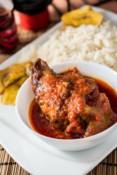 Regional African Food on white plate on wooden background