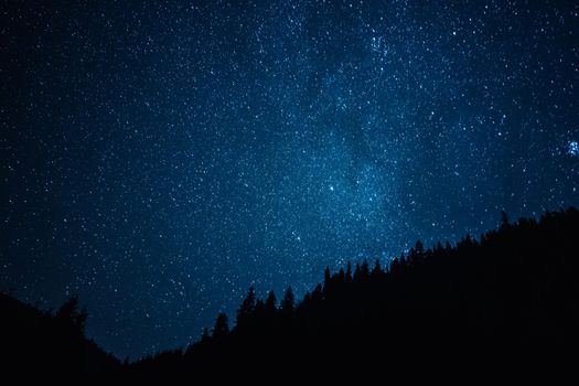 Night sky with stars, satellites. Milky Way passing in long exposure. Beautiful panorama view with rock, mountain. Nature, universe, galaxy, astronomy concept. High quality photo