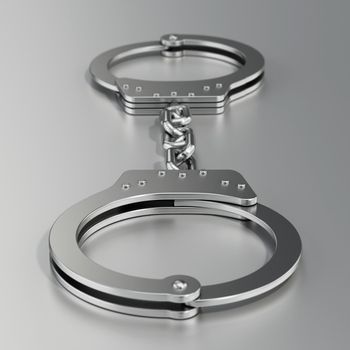 Handcuffs standing on gray background. 3D illustration.