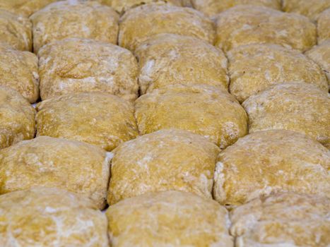 Culinary flour pastries laid out in a row. Pastry from flour dough. The process of preparing sweet food. Dessert from dough. Culinary dessert recipe.