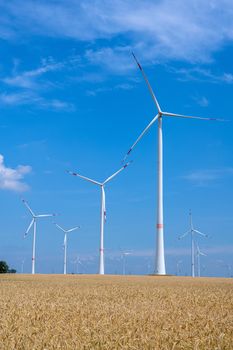 Wind energy plants in a grainfield seen in Germany