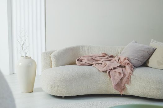 Modern concept of living room interior with design sofa, pillow, blanket