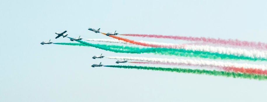 tricolor braids of the Italian military aviation, flight during an exhibition, the smoke of the planes forms the colors of the Italian flag