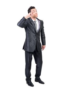 Full body of funny clever male entrepreneur in formal suit touching head and looking at camera against white background