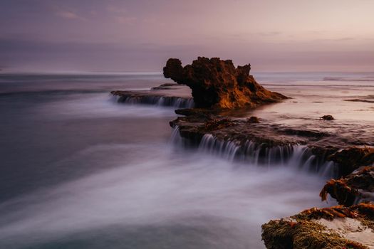 The iconic Dragon Head Rock at sunset on the Number Sixteen Beach in Rye, Victoria, Australia