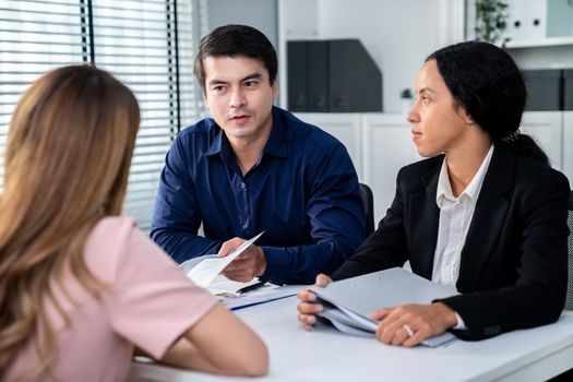 A young female asian candidate tries to impress her interviewer by being competent. International company, multicultural environment in workplace.