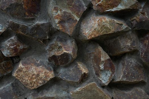 Close-up view of rough stone wall textured background