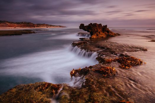 The iconic Dragon Head Rock at sunset on the Number Sixteen Beach in Rye, Victoria, Australia