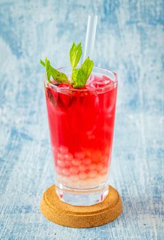 Fruity Bubble Tea in glass cup on blue background