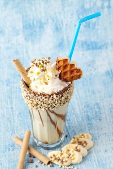 Chocolate milkshake with banana on blue background