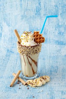 Chocolate milkshake with banana on blue background