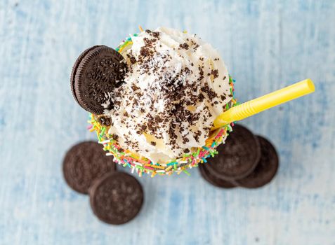 Cream and chocolate milkshake on blue background