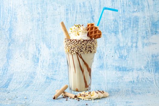 Chocolate milkshake with banana on blue background