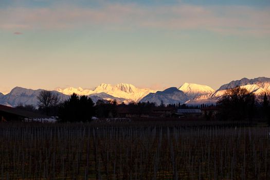 View of the Italian countryside with alp mountains on the background in the winter season