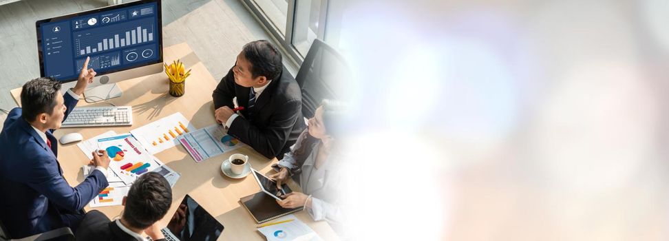 Smart businessman and businesswoman talking discussion in widen group meeting at office table in a modern office interior. Business collaboration strategic planning and brainstorming of coworkers.