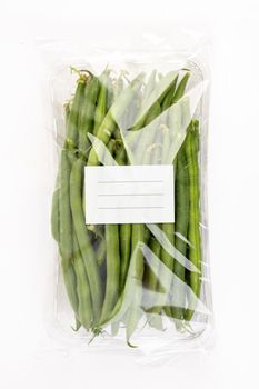 Package of green french beans with white label in isolated white background