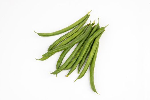 Pile of green french beans in isolated white background.