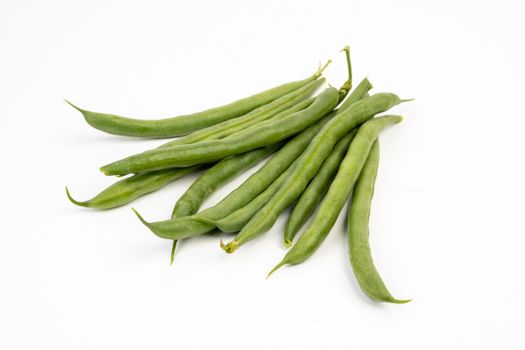 Pile of green french beans in isolated white background.