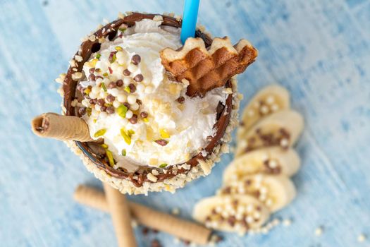 Chocolate milkshake with banana on blue background