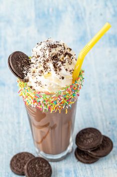 Cream and chocolate milkshake on blue background