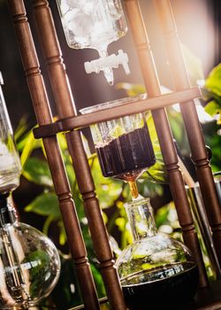 cold drip coffee tower with soft-focus and over light in the background