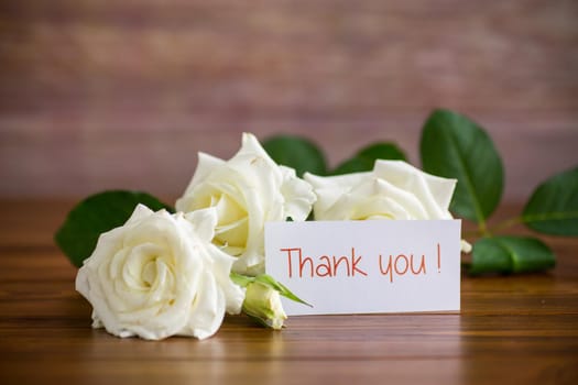 bouquet of beautiful white roses on a wooden table