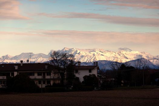 View of the Italian countryside with alp mountains on the background in the winter season