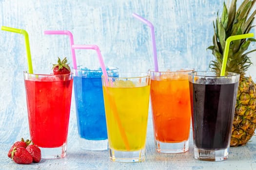 Refreshing frozens in various fruits and colors on a blue background.