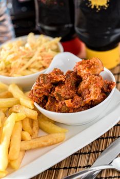 Regional African Food on white plate on wooden background