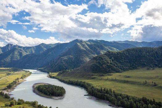 Colorful view of the mountains and the Katun River, with an island in the Altai Mountains, Siberia, Russia. View from the observation deck in the mountains. The concept of recreation and tourism