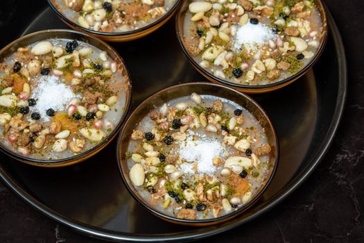 Traditional Turkish Dessert is Asure "Noah's Pudding" on wooden background