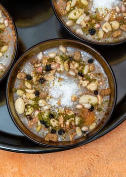 Traditional Turkish Dessert is Asure "Noah's Pudding" on wooden background