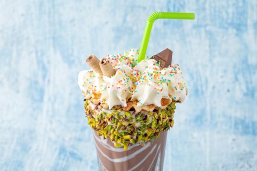 Cream and chocolate milkshake on blue background