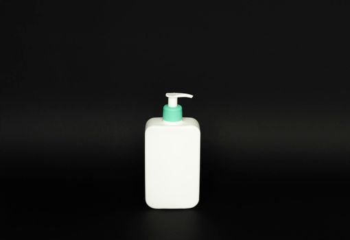 White unbranded plastic dispenser pump bottle on black background. Cosmetic package mockup, liquid soap flacon, hand sanitizer without label, shampoo organic spa, shower gel