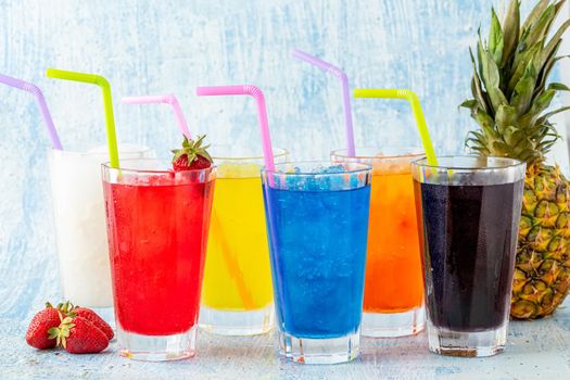 Refreshing frozens in various fruits and colors on a blue background.