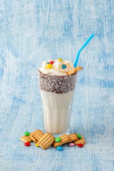 Milkshake with milk and baby biscuit decorated with dragee sugar.