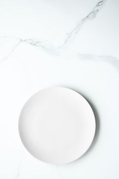 White empty plate on marble, flatlay - stylish tableware, romantic table decor and food menu concept. Serve the perfect dish